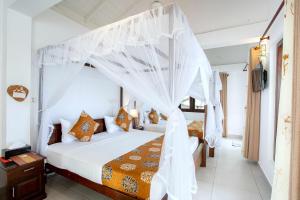 a bedroom with a bed with a canopy at Glamour Mirissa in Mirissa