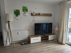 a living room with a flat screen tv and a lamp at little lake Faakersee in Faak am See