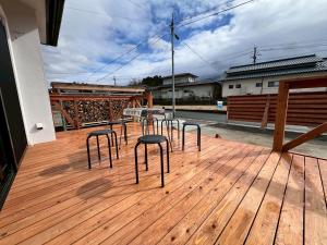 a group of stools sitting on a wooden deck at 季紀の杜阿蘇 in Aso +17 photos