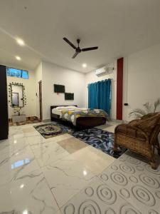 a bedroom with a bed and a ceiling fan at Vasudha Homestay in Sibsāgar