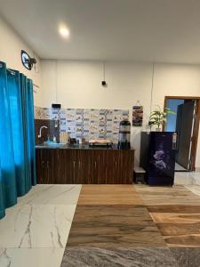a room with a counter and a sink in it at Vasudha Homestay in Sibsāgar