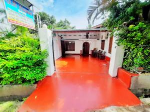 an entrance to a house with a red floor at JP Rest House in Trincomalee