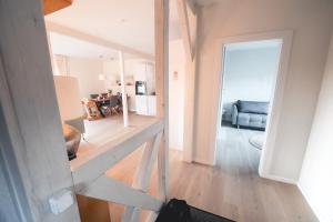 a view of a living room from the hallway of a house at Ferienhaus FachWerkPerle am Alfsee in Rieste