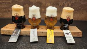 three glasses of beer on a wooden board at Speidel´s BrauManufaktur in Ödenwaldstetten