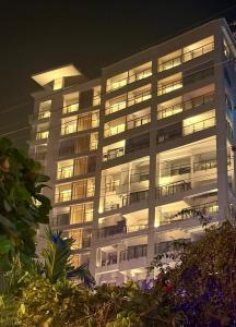 a tall building with its lights on at night at Hotel Grand Pacific in Cox's Bazar