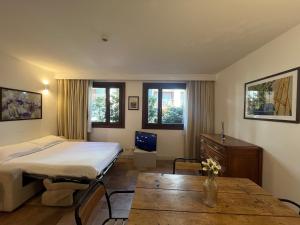 a hotel room with a bed and a table at Alpesmith - Bike & Ski apartments in Bardonecchia