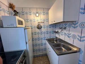 a small kitchen with a sink and a microwave at S Marco Apartments - Urban Boutique & Venice Link in Mestre +91 photos