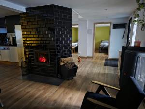 a fireplace in a living room with a fire place at White in Biała