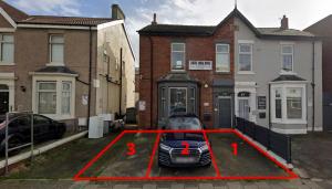 a car parked in a parking lot in front of a house at Cadeby Lodge in Blackpool
