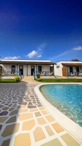 a house with a swimming pool in front of it at Delta Land Bungalows in Crisan