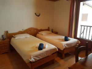 a bedroom with two beds with towels on them at La Maison de Joséphine in Risoul