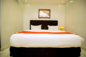 a bedroom with a large bed in a room at Buffalo Village in Kigali