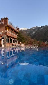 a large swimming pool in front of a building at KASBAH LA DAME BIJA in Ouirgane
