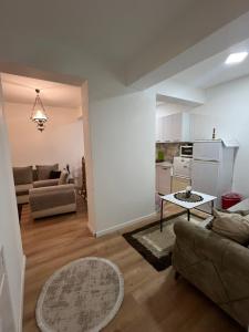 a living room with a couch and a table at Famely apartmen in Prizren +15 photos