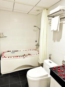 a bathroom with a tub with red hearts on it at Sunrise Villa Hanoi in Hanoi