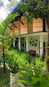 a house with a bench in front of it at Simoya Nature Park in Dambulla