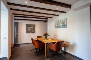 a dining room with a wooden table and chairs at Ferienhaus Carpe diem in Bodman-Ludwigshafen