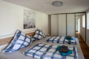 a bedroom with two beds with blue and white pillows at Ferienhaus Carpe diem in Bodman-Ludwigshafen