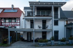 a white building with a bird sitting on the balcony at Ferienhaus Carpe diem in Bodman-Ludwigshafen