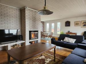 a living room with a couch and a fireplace at Evita in Kosta