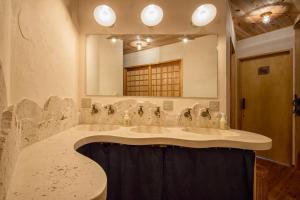 a bathroom with a marble sink and a mirror at Twin Dome Ryugu in Hokuto