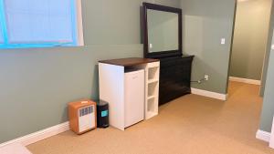 a room with a dresser and a mirror and a cabinet at Private King Bed Room Near UPEI & Downtown Cozy Retreat Near Everything in Charlottetown