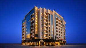 a rendering of a hotel building at night at Jacob's Garden Hotel in Dubai