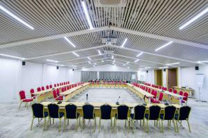 a large room with a swimming pool with red chairs at SUNSET HOTEL in Nouakchott +41 photos