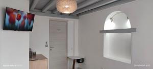 a room with a white wall with a chandelier at Mykonos Marina in Mikonos +27 photos