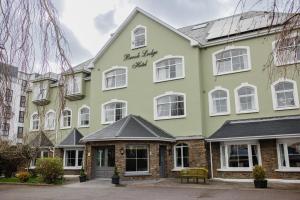 a large green building with a sign on it at Brook Lodge Boutique Hotel in Killarney