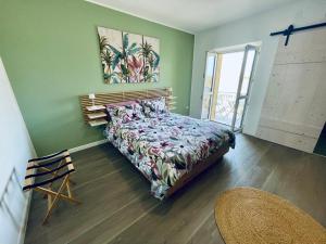 a bedroom with a bed in a room with green walls at Raffaello's House - Aeroporto Falconara - Ancona in Ancona Falconara Airport