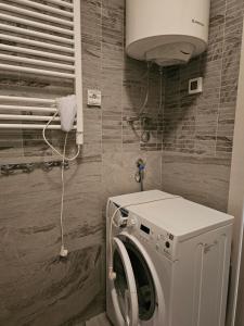 a laundry room with a washing machine in it at Apartment Pasha in Pržno