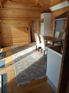 a kitchen and dining room with a table and chairs at Holzhaus Riegersburg in Riegersburg