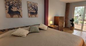 a bedroom with a bed with two paintings on the wall at Luxe Vista in Serra