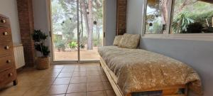 a bedroom with a bed in a room with windows at Luxe Vista in Serra +29 photos