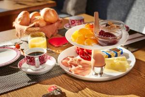 a table with a plate of food on a table at Pension KaraMia in Fichtelberg +8 photos