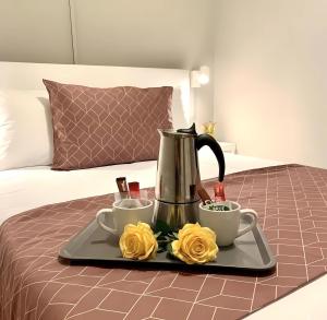 a tray with two cups of coffee and roses on a bed at Casa de Silvia in Arrecife