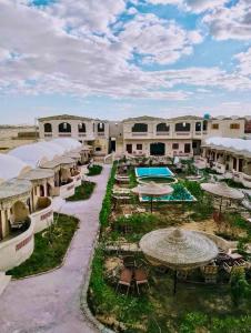 an aerial view of a resort with a pool and umbrellas at King Siwa in Siwa