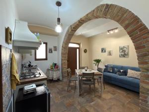 a living room with a blue couch and a table at Risorta Ponente in Boiano