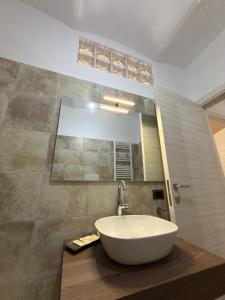 a bathroom with a white sink and a mirror at Risorta Ponente in Boiano +31 photos