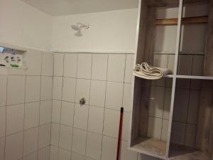 a shower with a glass door in a bathroom at Susans cottages diani beach in Ukunda +8 photos