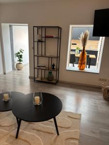a living room with a black table and a mirror at Appartement chez pépite in Namur +4 photos