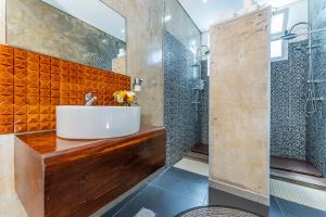 a bathroom with a sink and a shower at A-Típica GuestHouse in Ponta Delgada +74 photos