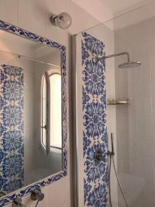a blue and white bathroom with a mirror and a shower at Casa Blu in Anacapri +68 photos