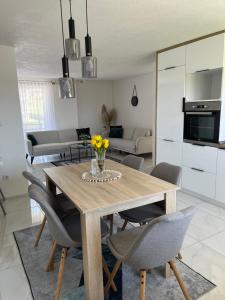 a dining room with a wooden table and chairs at Apartman Stari Grad in Cazin