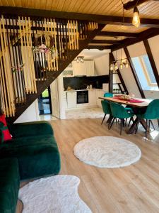 a living room with a green couch and a table at Zago Alpin in Câmpulung Moldovenesc +56 photos