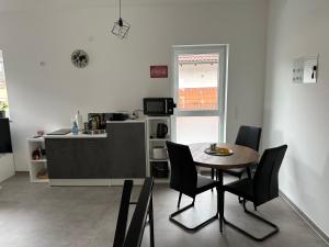 a kitchen and dining room with a table and chairs at Thiels Mansion in Sankt Sebastian