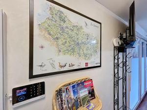 a map hanging on a wall next to a shelf with books at Studio avec terrasse in Amiens