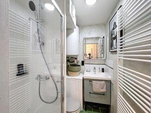 a bathroom with a shower and a toilet and a sink at Studio avec terrasse in Amiens