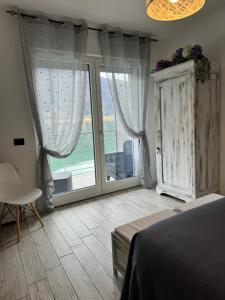 a bedroom with a bed and a large window at Adeline in Dascio